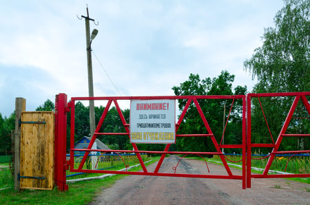 Warning sign Attention! Thirty-kilometer exclusion zone begins here on barrier at entrance to...