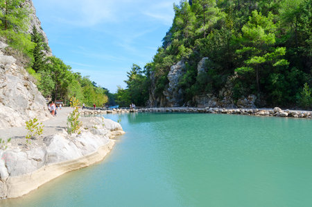 GOYNUK CANYON, TURKEY - OCTOBER 8, 2023: Unidentified tourists walk along road along mountain lake in Goynuk Canyon, Turkeyのeditorial素材