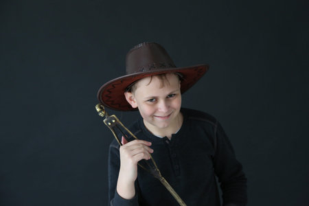 Portrait of a boy in a hat on a black background.の写真素材