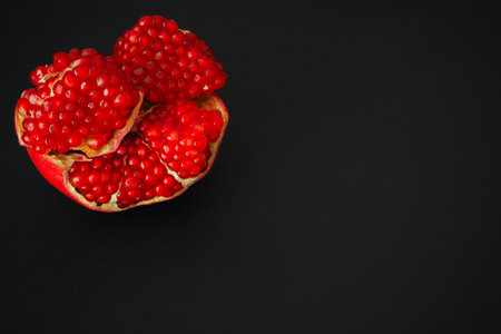 The fruit of a ripe pomegranate. Red fruit with juicy grains.の写真素材