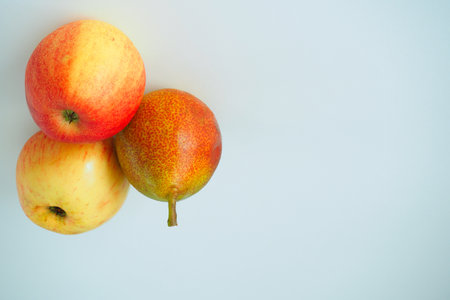 Ripe fruit. Two pears and an apple on a white background.の写真素材