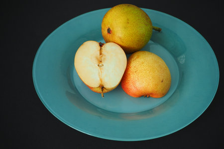 Ripe fruit. Pear on a platter cut into pieces.の写真素材