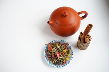 Chinese clay kettle for tea ceremony with herbs and cinnamon sticks.の写真素材