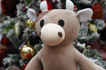 The symbol of 2021 is a toy bull with a Christmas decor on the background of a Christmas tree.の写真素材