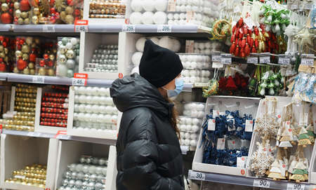 Christmas tree toys shop. Masked shoppers at a Christmas toy store.の写真素材