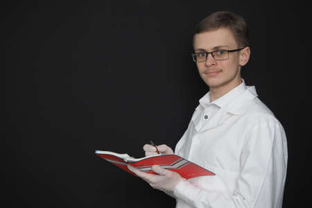 young man, doctor, European appearance in a medical white robe. High quality photoの写真素材