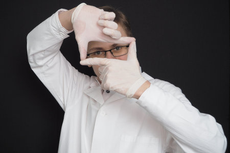 Portrait of a young doctor of European appearance in a white medical gown. Medical student. High...
