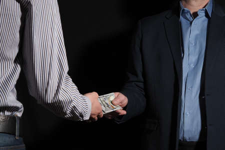 Business and finance. Transfer of cash. The American dollar from hand to hand.の写真素材