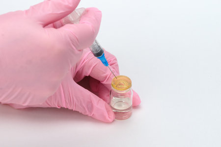 Science and medicine. Vaccination of the population. Hands of a medical professional picking up a...