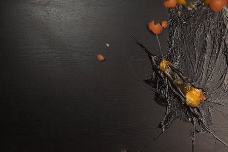 A broken egg on black