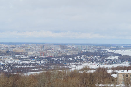 Panoramic view from above of a large industrial city by the river in winter. High quality photo