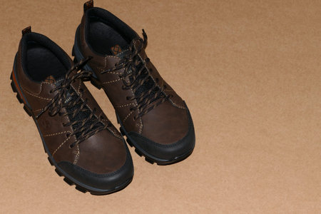 Fashionable mens shoes, a pair of brown leather shoes isolated on a gray background with a place for...