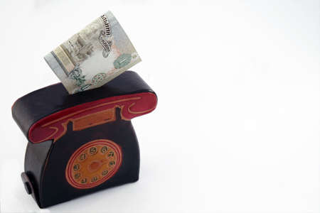 Piggy for money or purse with paper banknotes in isolation on a white background. Ukrainian hryvnia. High quality photoの写真素材