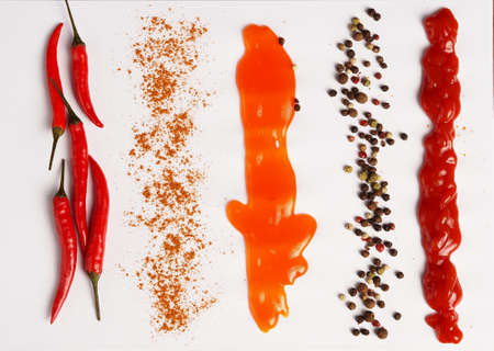 Chili peppers, spices and sauces on a white background. close-up. High quality photoの写真素材