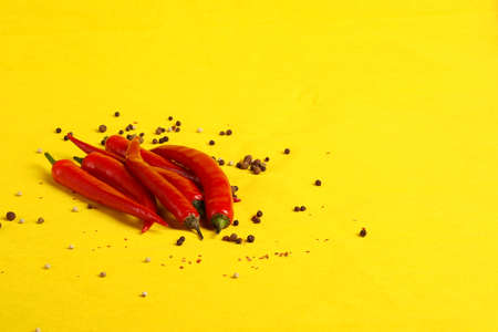 Red hot chili peppers on a yellow background. High quality photoの写真素材