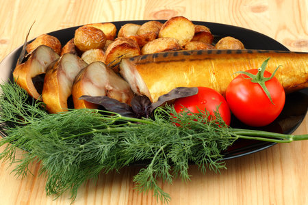 Smoked mackerel on a plate with tomatoes and dill potatoes. High quality photo