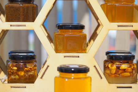 Natural honey in jars. A beautiful showcase for the sale of natural honey. High quality photo
