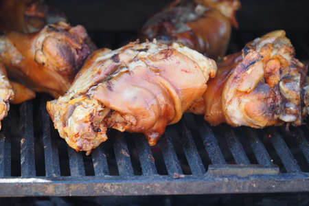 Grilling food. The meat is barbecued with coals. Pork knuckle with apples on the barbecue. High quality photoの写真素材