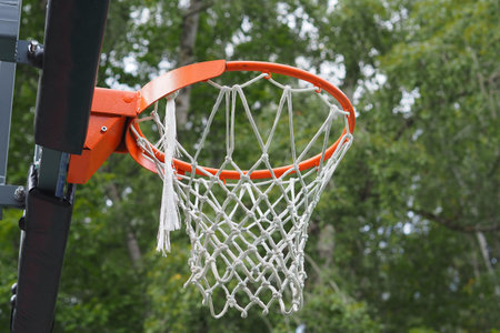 basketball hoop with net on a sports ground in an outdoor park. High quality photo