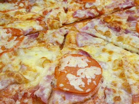 Tasty pizza. Pizza with cheese, salami and tomatoes. Cheese crust. High quality photoの写真素材