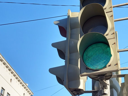 Traffic light on a post near the roadway. Regulated pedestrian crossing. High quality photo
