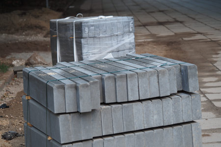 Improvement of the city territory. Laying new curbs in the park. The curbs are on a pallet. ... High...