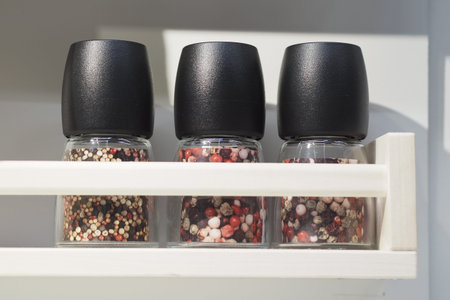 Jars of spices on a white shelf in the kitchen. High quality photoの写真素材