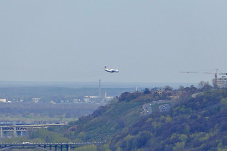 The plane flies in the sky over the city. High quality photo