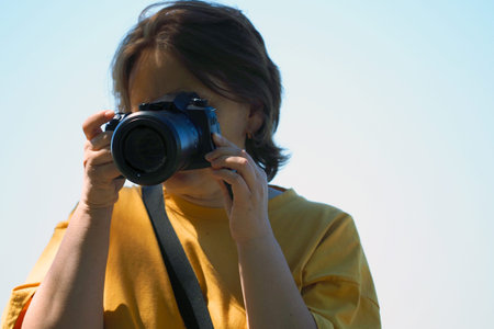 Girl with a camera in the summer on the street in sunny weather. high quality photo