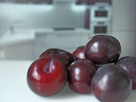 Ripe juicy plums close-up on the kitchen table. high quality photoの写真素材