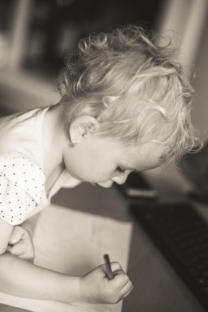 girl draws felt-tip pens in black and white portraitの写真素材