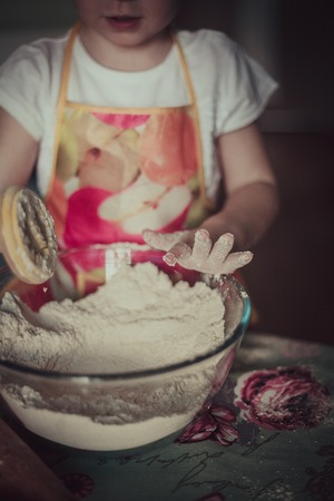 little girl baking cookies. Hands in flourの写真素材