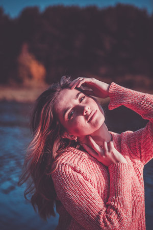 portrait of a beautiful girl at the lake shoreの写真素材