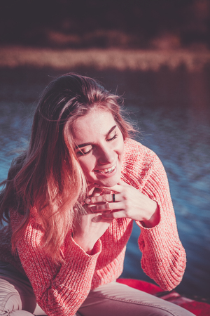 portrait of a beautiful girl at the lake shoreの写真素材