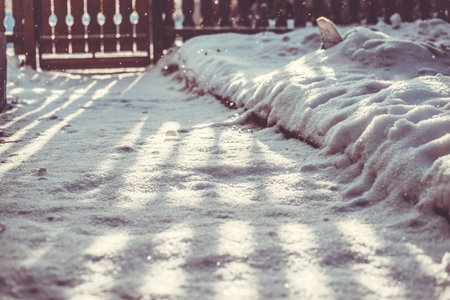 sunny winter morning patio. carved wooden fenceの写真素材