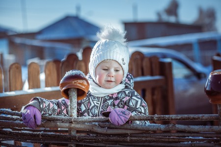 portrait of a child in a winter snowy dayの写真素材