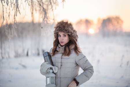 girl with   a lantern in a winter forestの写真素材