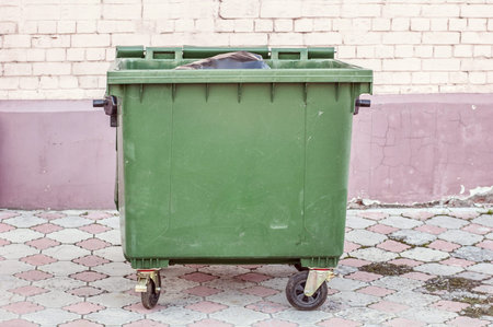 garbage bin on the brick wall background. Garbage bin near buildingの写真素材