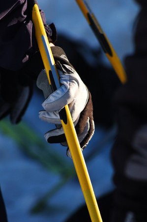 A hand in a ski glove resting on a ski stickの写真素材
