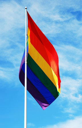 Rainbow flag on the blue sky with clouds background in the Castro district of San Francisco,...