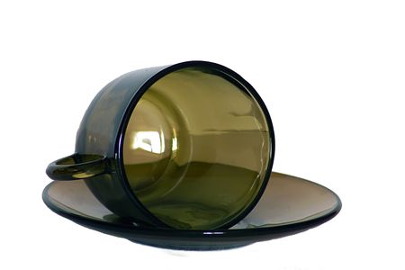 Empty cup on a saucer are made of brown glass, isolatedの写真素材