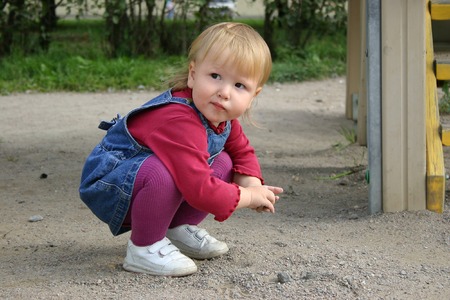 Beautiful  girl playing with sandの写真素材