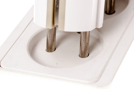 Macro shot of electricity plug in process isolated on whiteの写真素材
