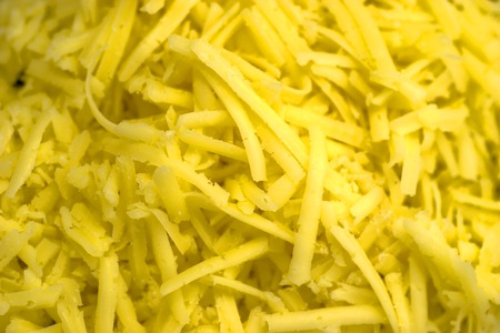 Abstract yellow shredded cheese backgroundの写真素材