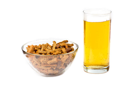 Transparent glass of Beer and bow with rusks isolated on whiteの写真素材
