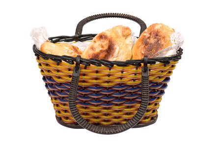 Basket full of pasties isolated on whiteの写真素材