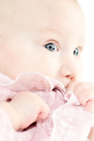 Baby girl in the age of 5 months isolated on white