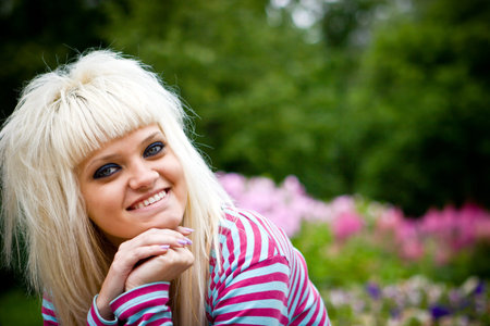 Happy young blond woman looking at youの写真素材
