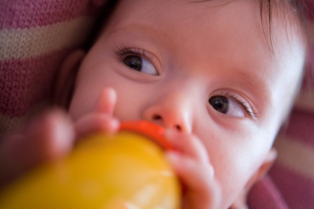 Adorable Seven month Baby eating from bottle closeupの写真素材
