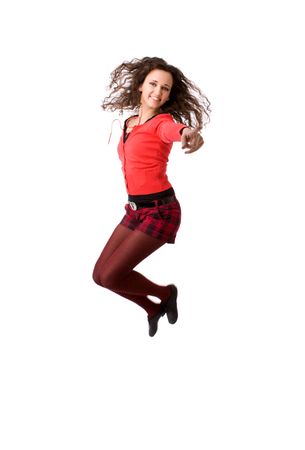 Young cheerful brunette woman jumping isolated on whiteの写真素材